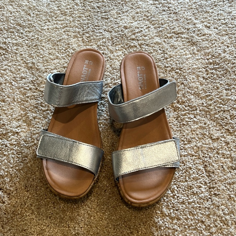 Naot brand women’s silver/cork sandal with adjustable straps.